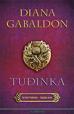 Diana Gabaldon, roman Tuđinka, ljubičasta naslovnica sa zlatnim grbom.